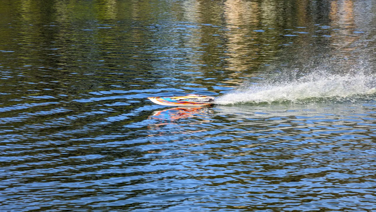 A radio-controlled model powerboat speeding across Spreckels Lake